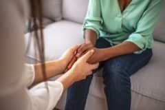 Close up African American psychotherapist holding clipboard, tou care giving